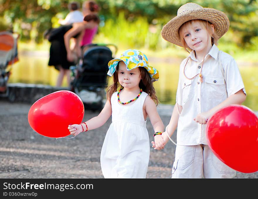 Young couple go on avenue in park