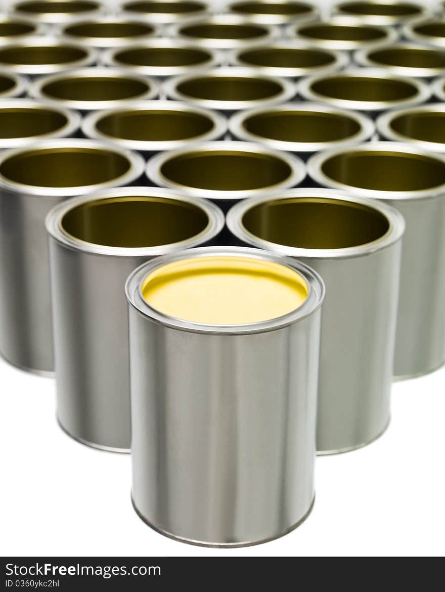 Yellow Paint can in front of a large group of Empty Paint Cans. Yellow Paint can in front of a large group of Empty Paint Cans