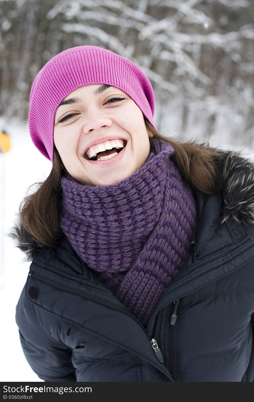 The young woman the brunette in a violet cap laugh