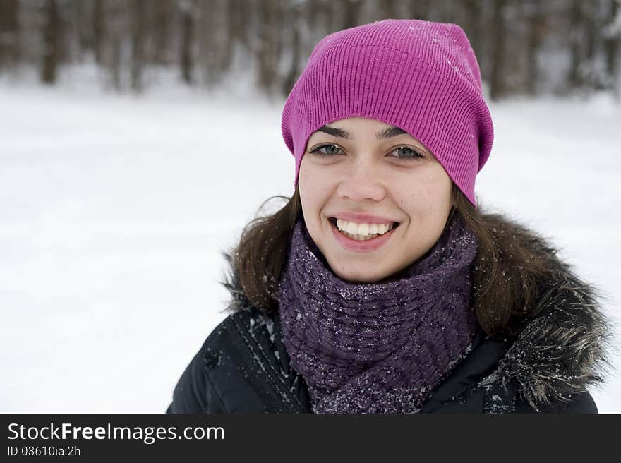 The young woman the brunette in a pink cap smile