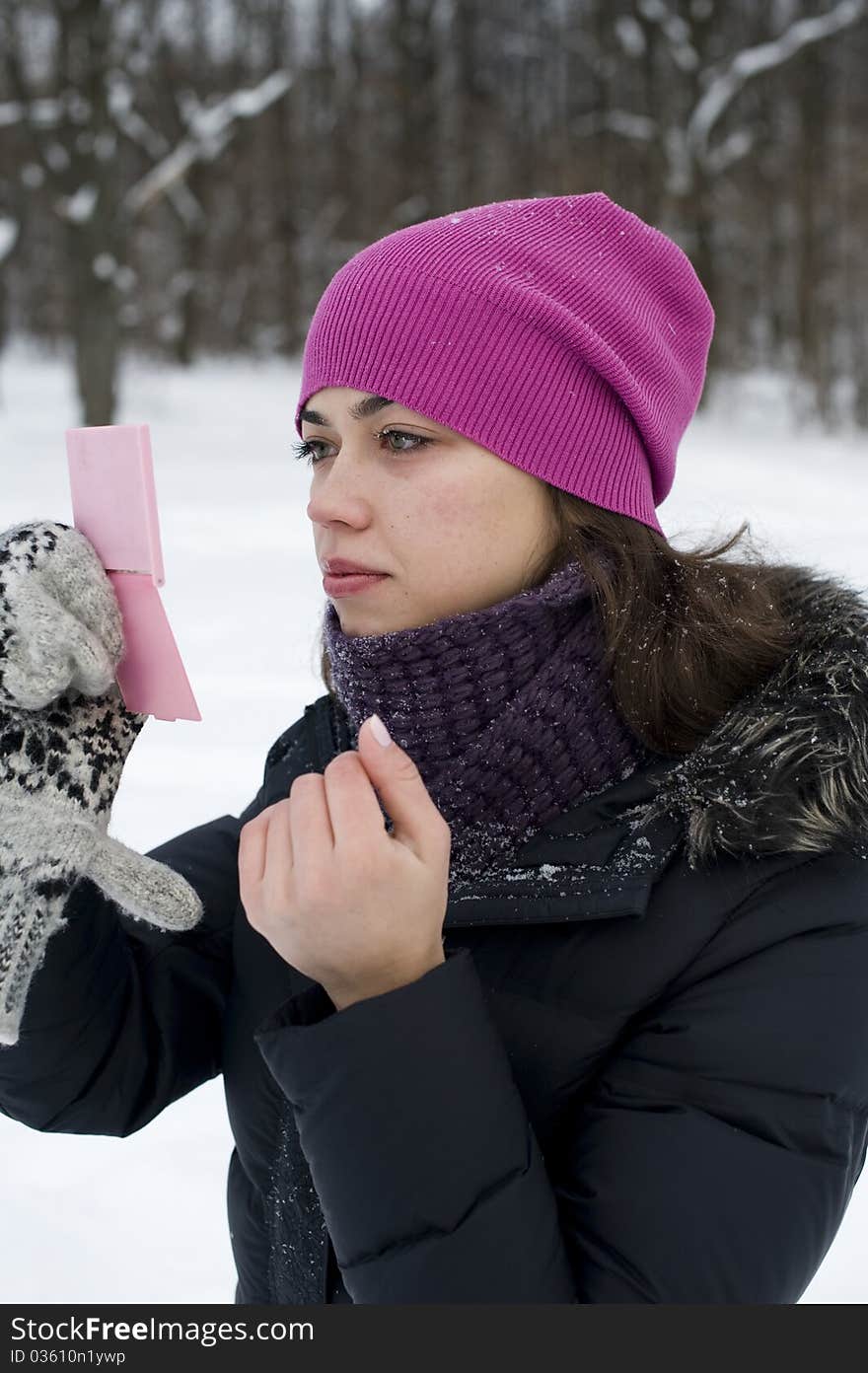 The young beautiful sexual woman looks in a mirror winter