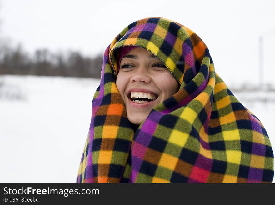 The young happy woman laughs having taken cover a