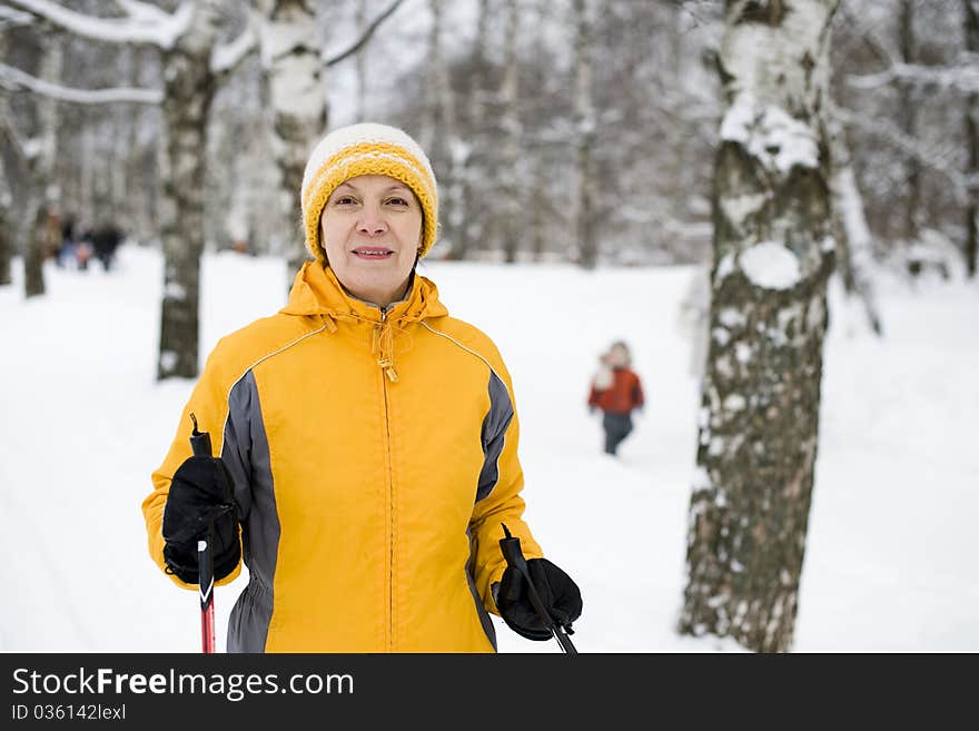 The happy woman in a bright yellow cap and a jacke