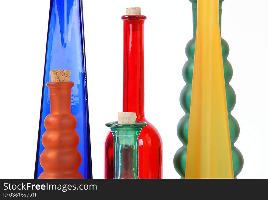 Colored glass vases on a white background