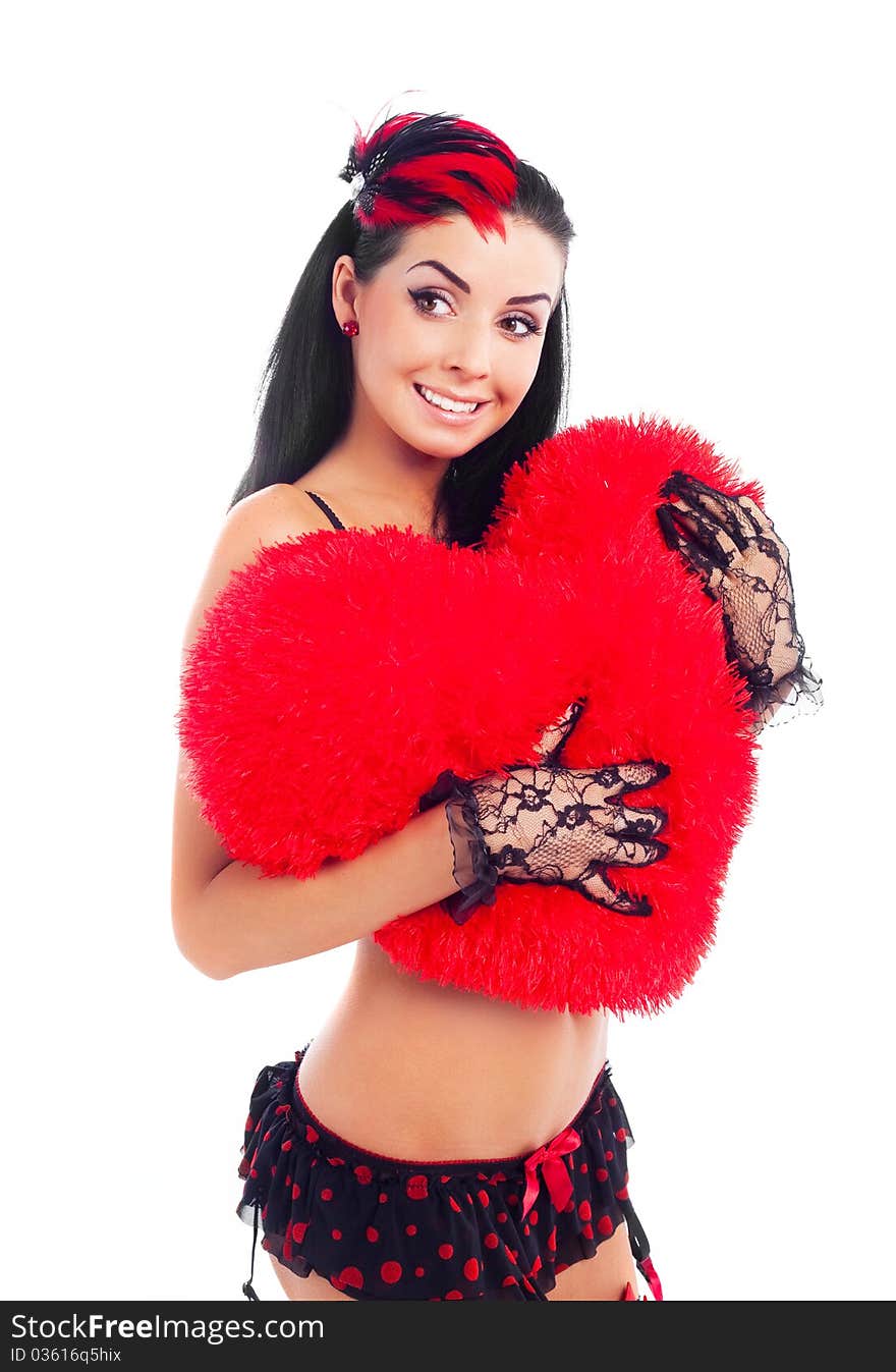 young brunette woman wearing beautiful underwear with a heart shaped pillow in her hands. young brunette woman wearing beautiful underwear with a heart shaped pillow in her hands