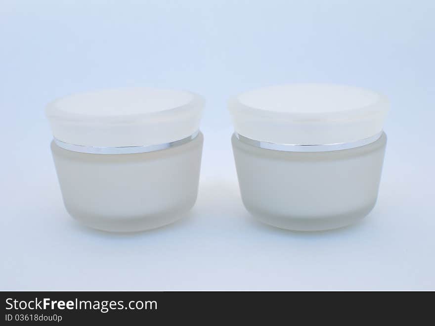 Two containers of cosmetic face cream close-up. Two containers of cosmetic face cream close-up