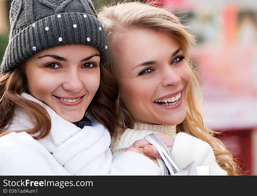 Two cheerful girls twins, in the street. Two cheerful girls twins, in the street