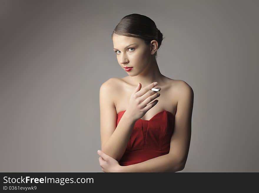 Beautiful elegant woman holding a cigarette. Beautiful elegant woman holding a cigarette