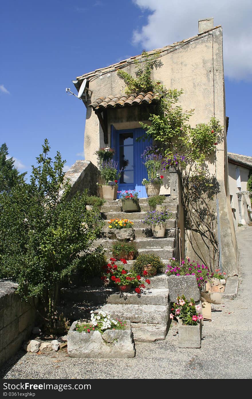 Old entrance and stairs with blue door, Provence