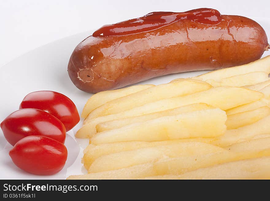 Sausage with a fried potato and tomatoes.