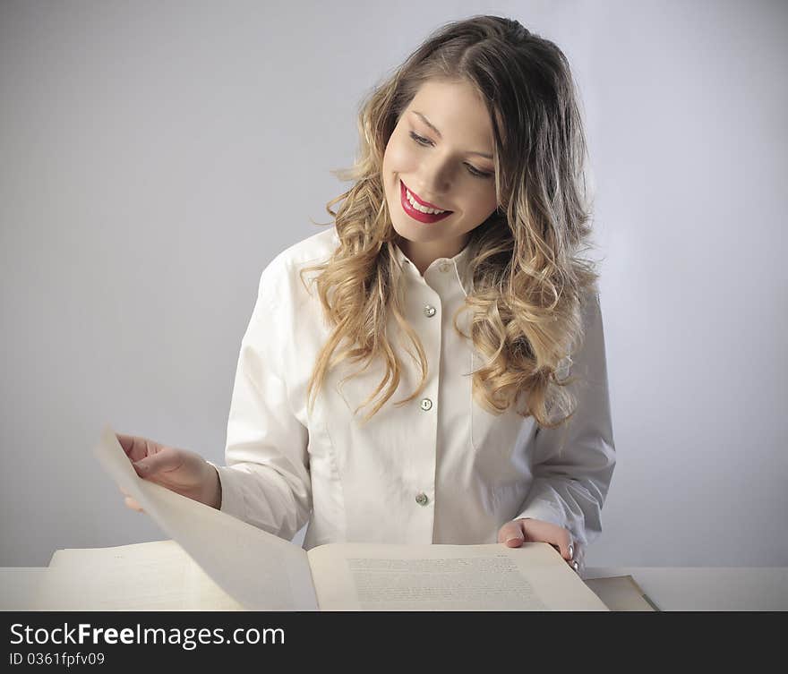 Smiling beautiful woman reading a book