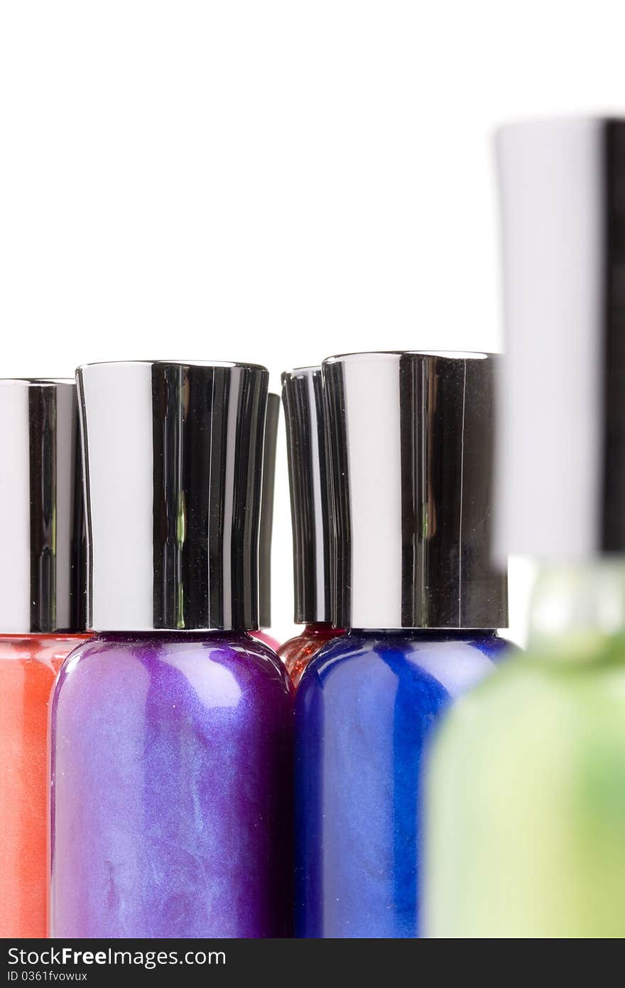 Different colored nail polish bottles on a white background.