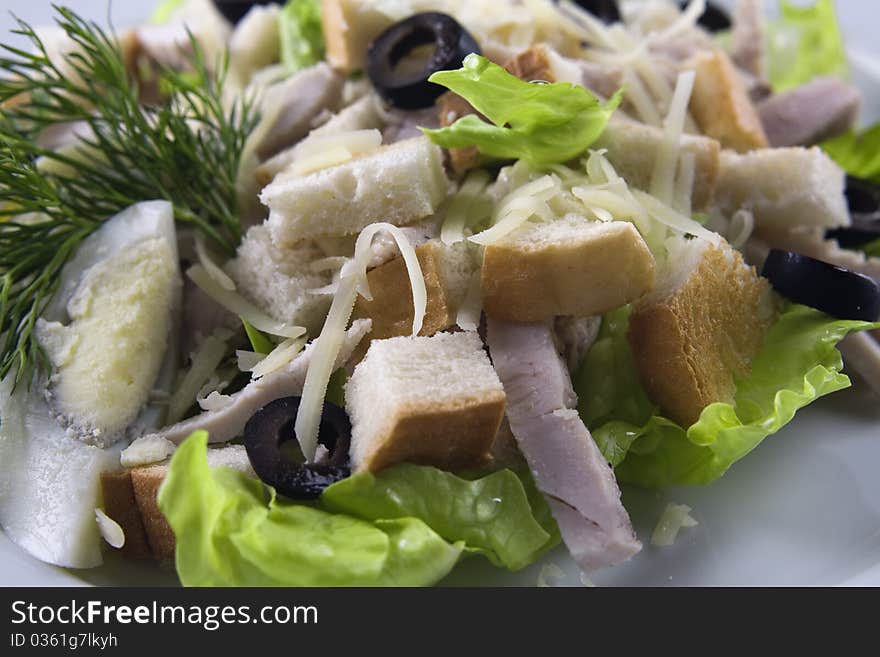 Chicken Caesar salad on white background close up