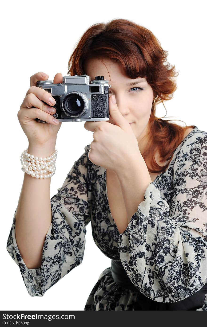 An image of a woman with a camera in her hands. An image of a woman with a camera in her hands