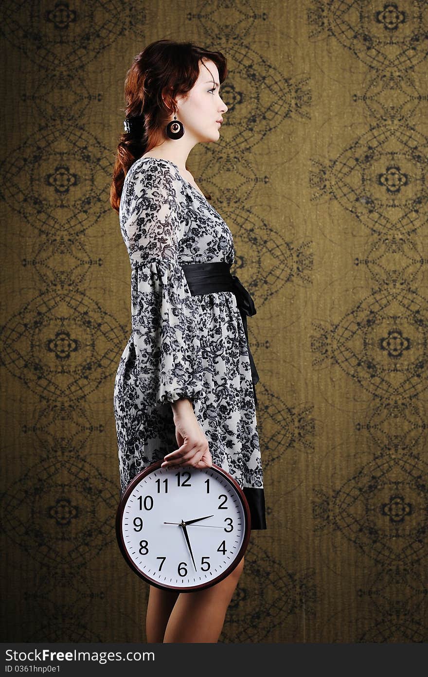 An image of a woman with a big clock. An image of a woman with a big clock