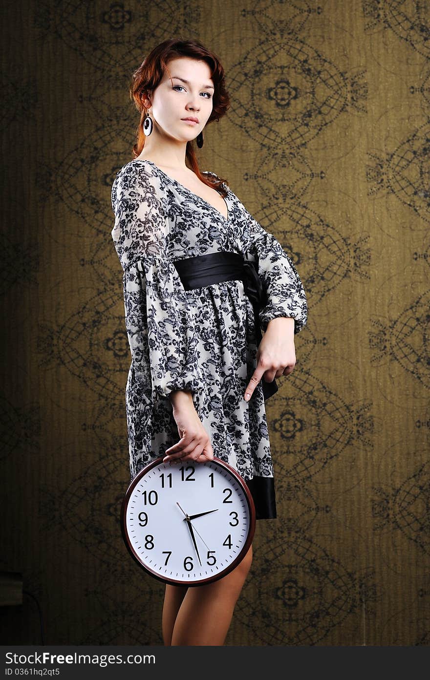 An image of a woman with a big clock. An image of a woman with a big clock