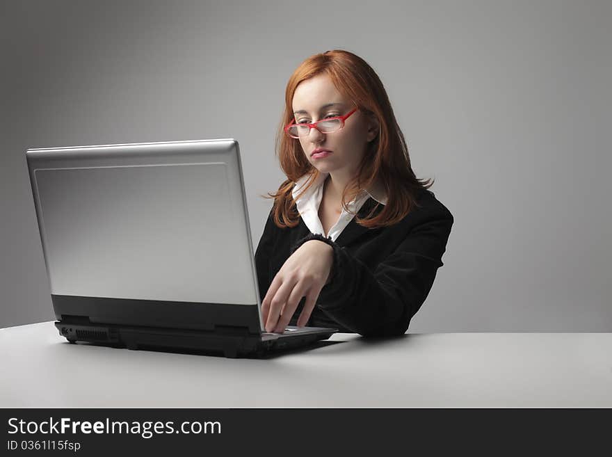 Young woman using a laptop at the office. Young woman using a laptop at the office