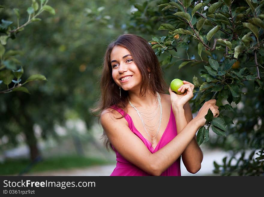 Beautiful young woman with apple