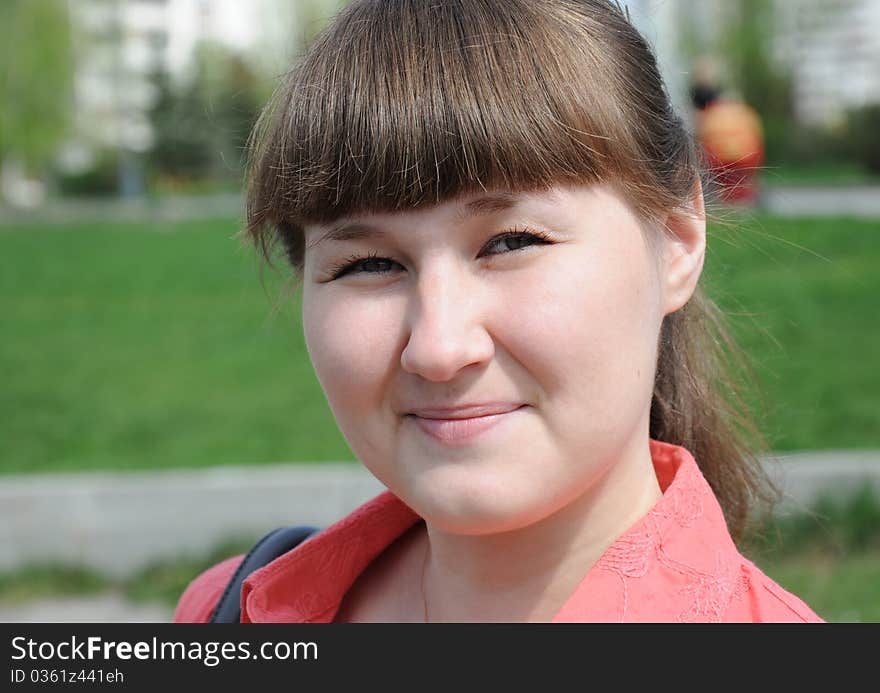 Outdoor portrait of squinting attractive young woman. Outdoor portrait of squinting attractive young woman