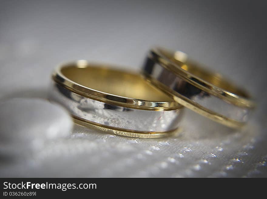 Two silver gold wedding ring placed on the waistcot. Two silver gold wedding ring placed on the waistcot