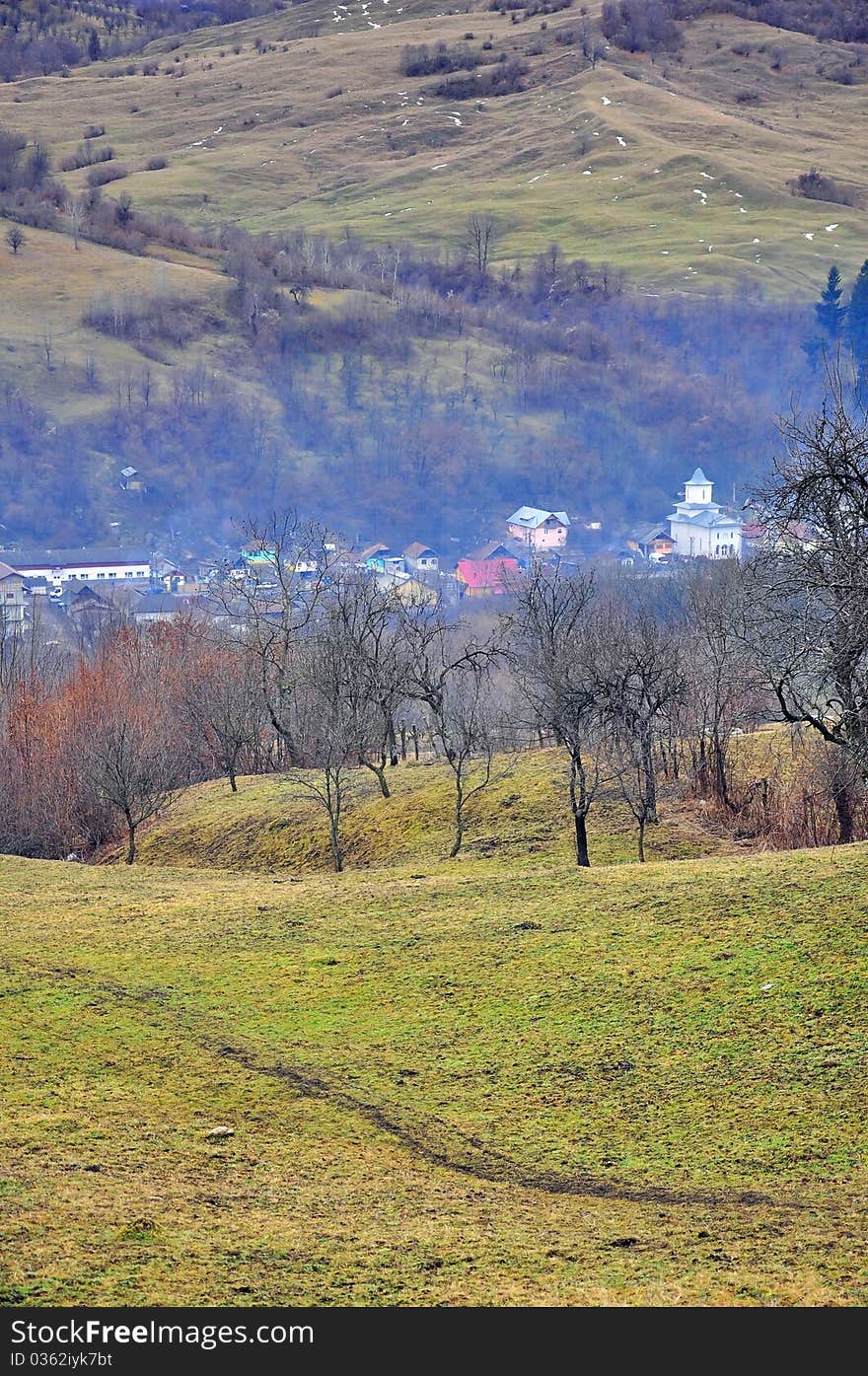 Path to foggy village in river valley