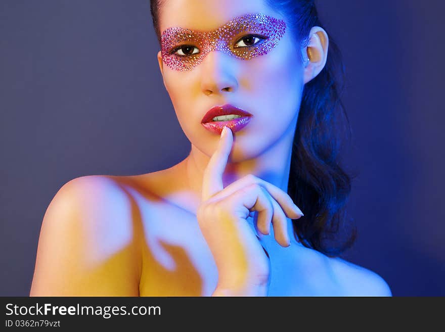 Portrait of beautiful woman with creative make-up, colour filters were used