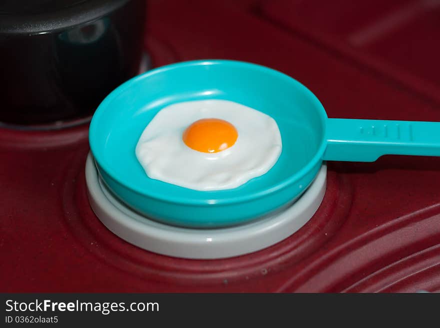 Plastic Toy Fried Egg in a Pan on a Stove