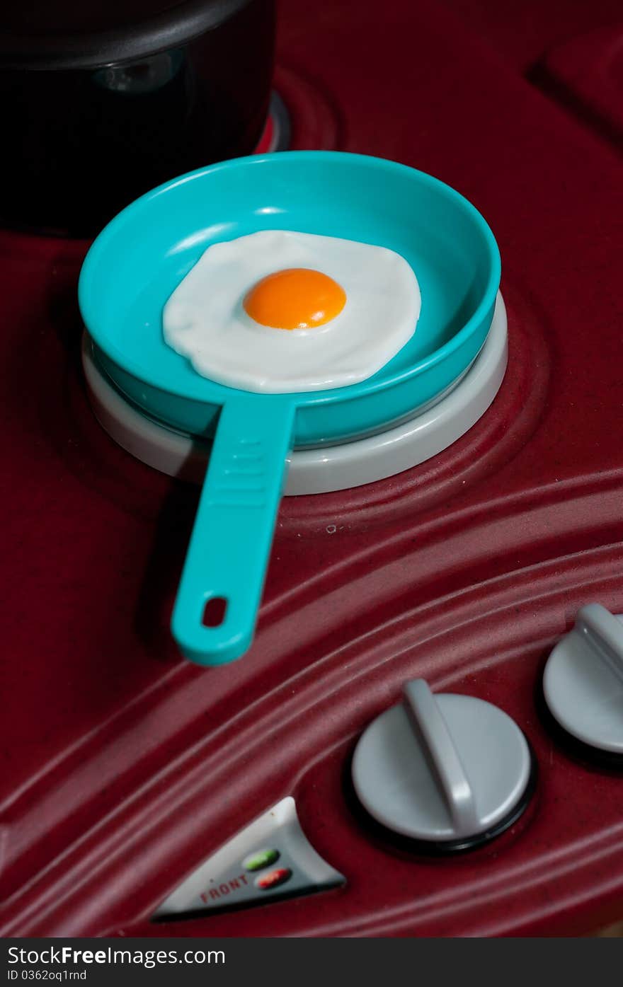 Plastic Toy Fried Egg in a Pan on a Stove