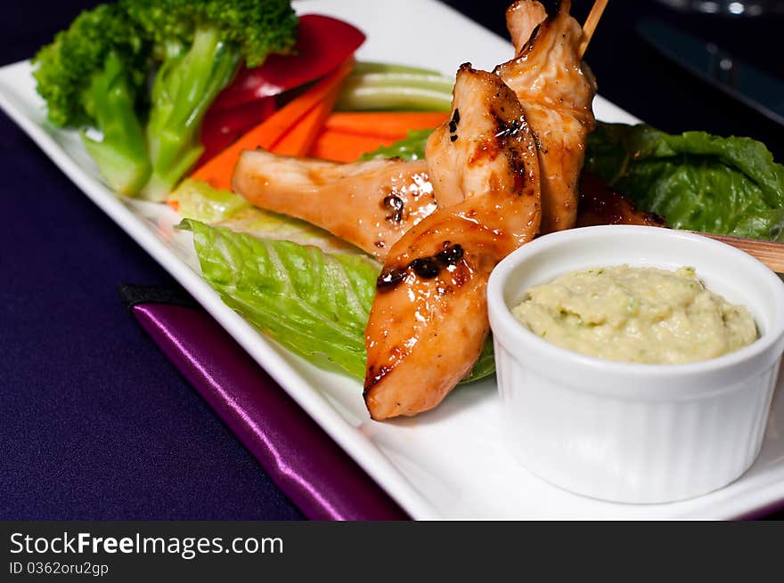 Chicken with Fresh Vegetables and Sauce served on a Plate. Chicken with Fresh Vegetables and Sauce served on a Plate