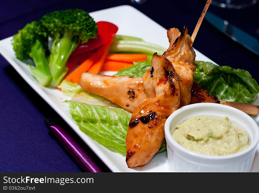 Chicken with Fresh Vegetables and Sauce served on a Plate. Chicken with Fresh Vegetables and Sauce served on a Plate