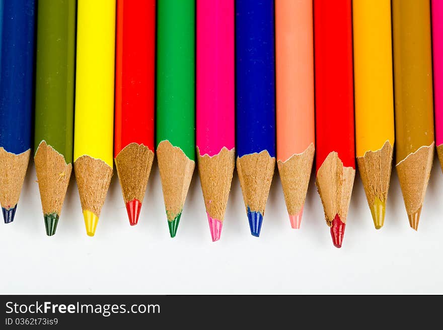 Colored pencils lined up in a horizontal row