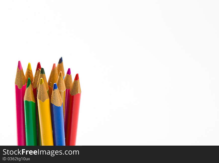 Standing colored pencils against a white background