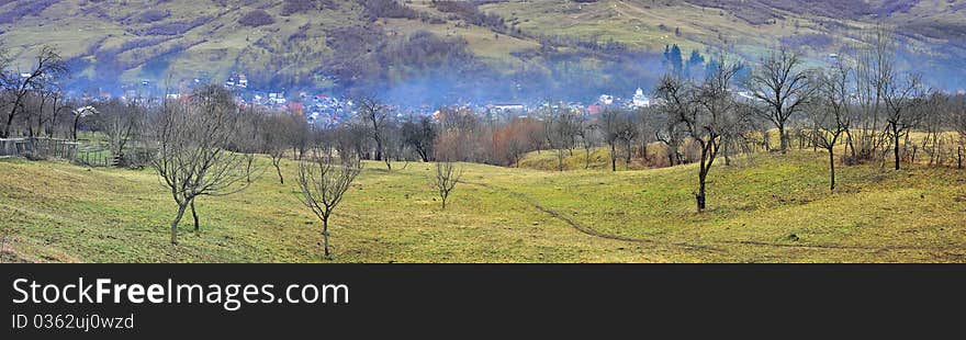 Fog panorama over village and orchard