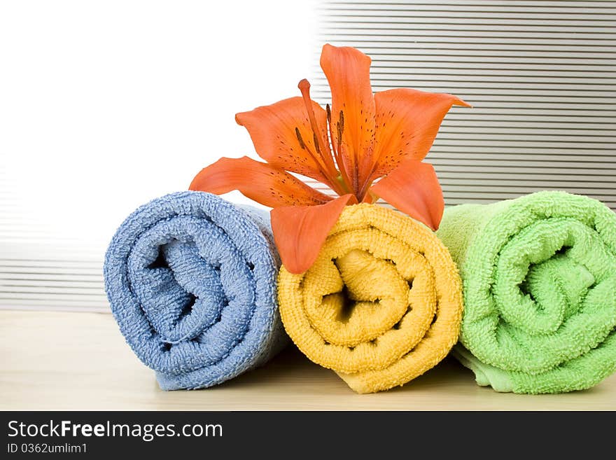 Colored towels are folded to lie next to them flower tiger lily