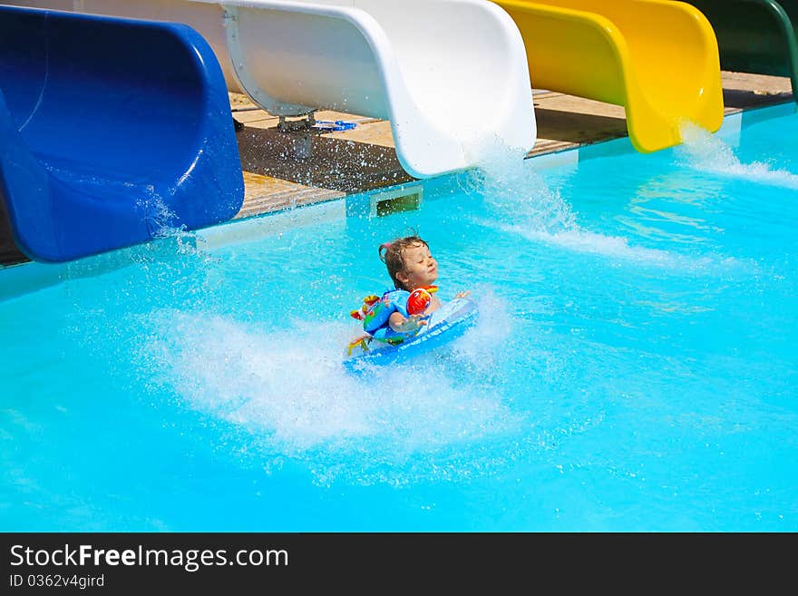 Little girl falls into the pool with water slides