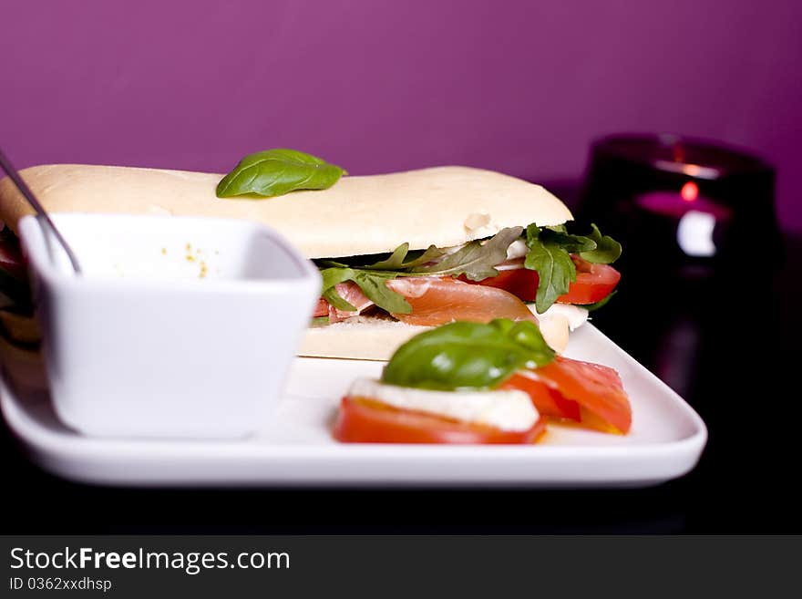 Long baguette sandwich with ham, fresh vegetables and pesto. Long baguette sandwich with ham, fresh vegetables and pesto