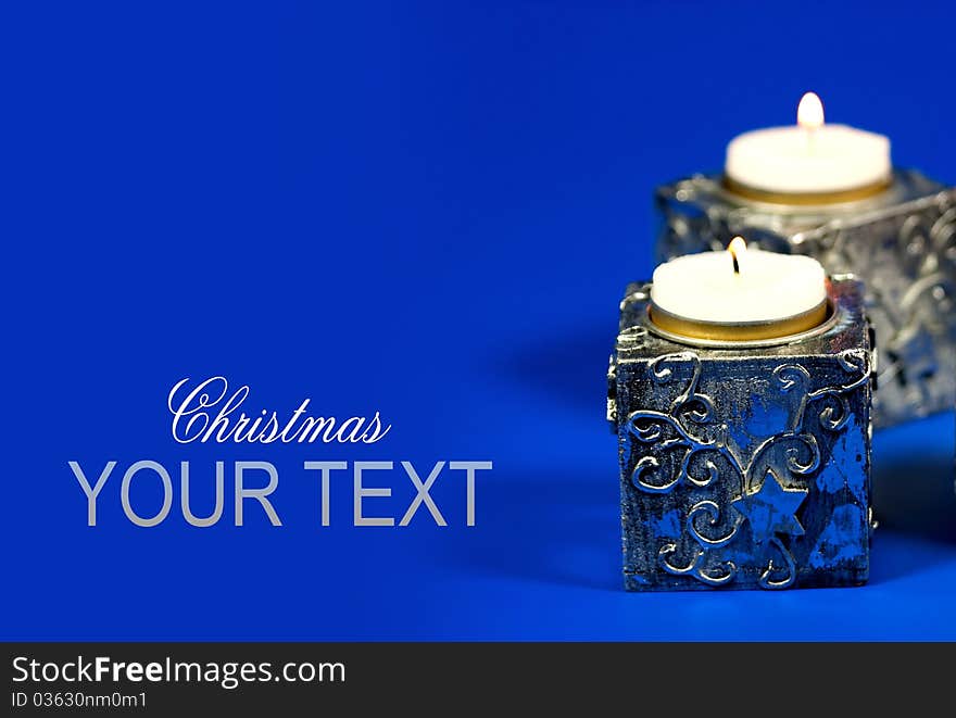 Silver Chrismas candle on blue background. Silver Chrismas candle on blue background