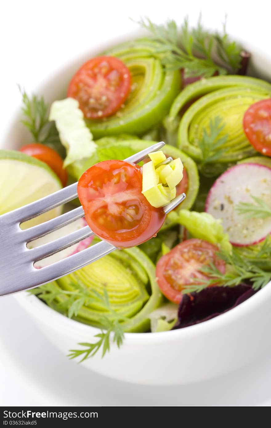 Some bits of salad on the fork close up