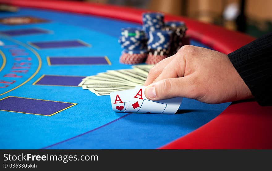 Hand With Chips, And $ Banknotes On Table