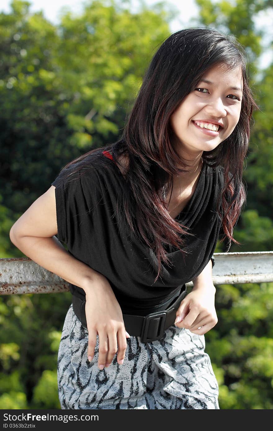 Attractive asian girl smiling in the park