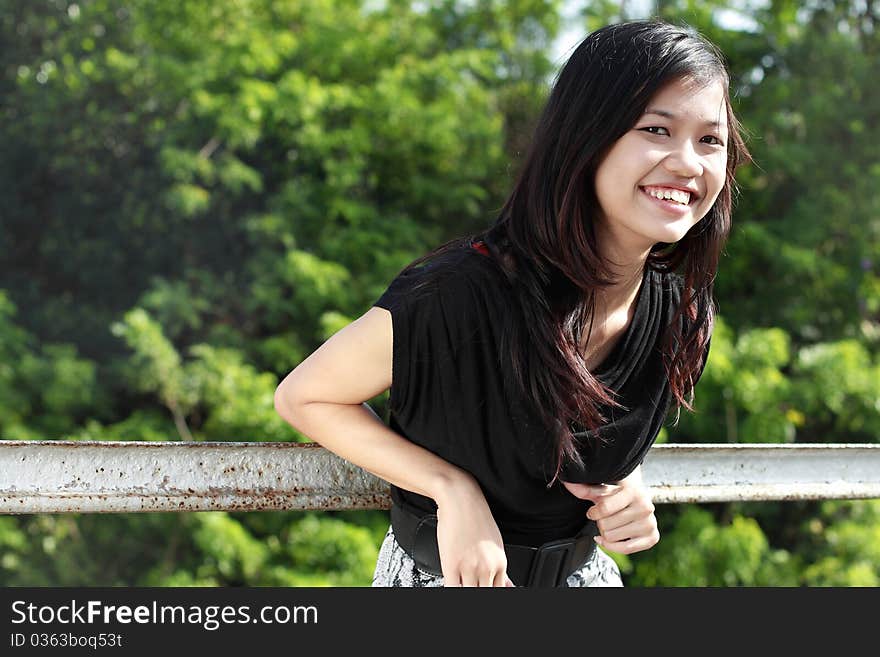 Attractive asian girl smiling in the park