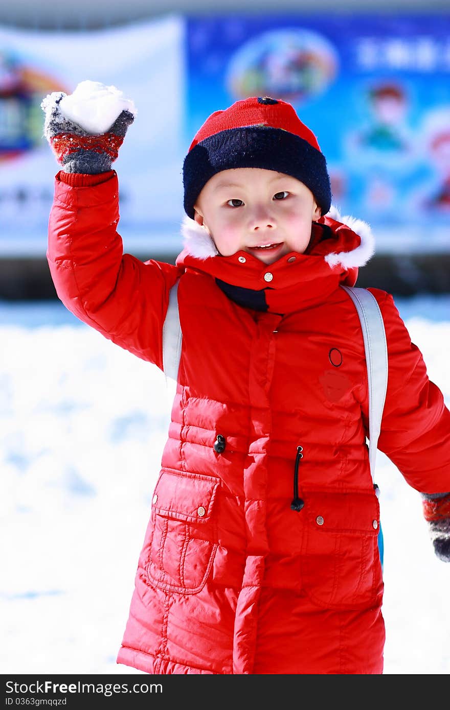 Asian boy is playing snow