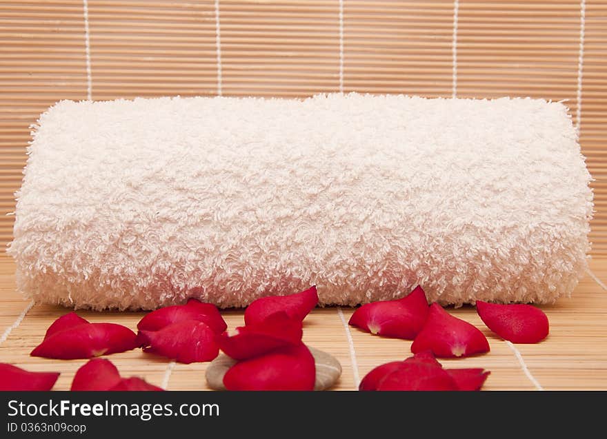 Spa scene with a towel and aromatic petals