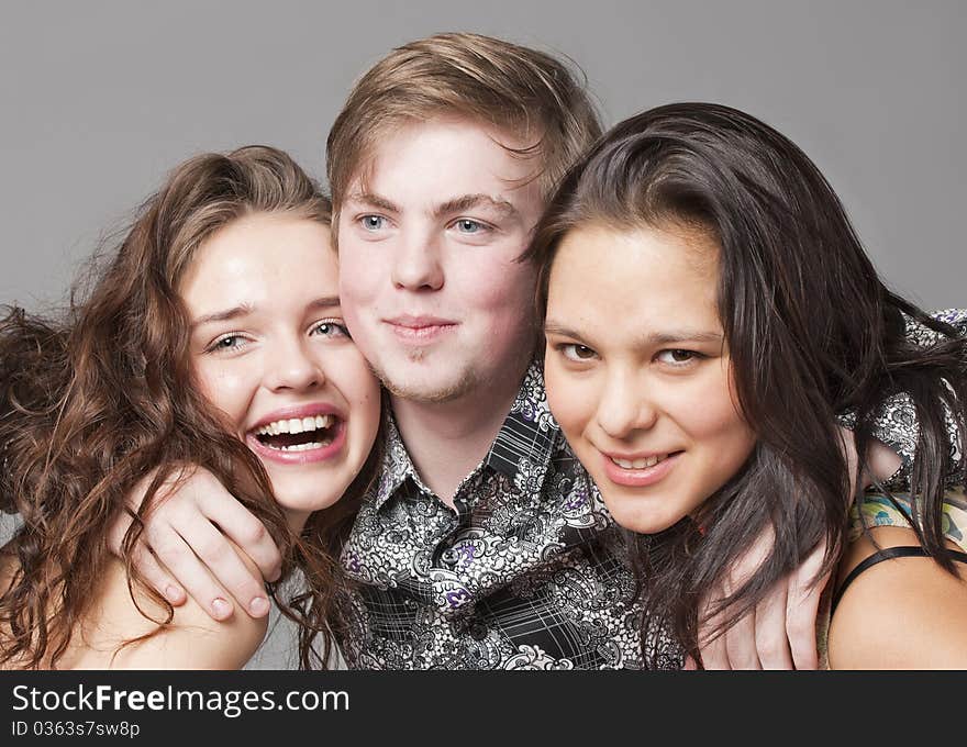 Two girl-friends and the young boy look in the chamber and smile