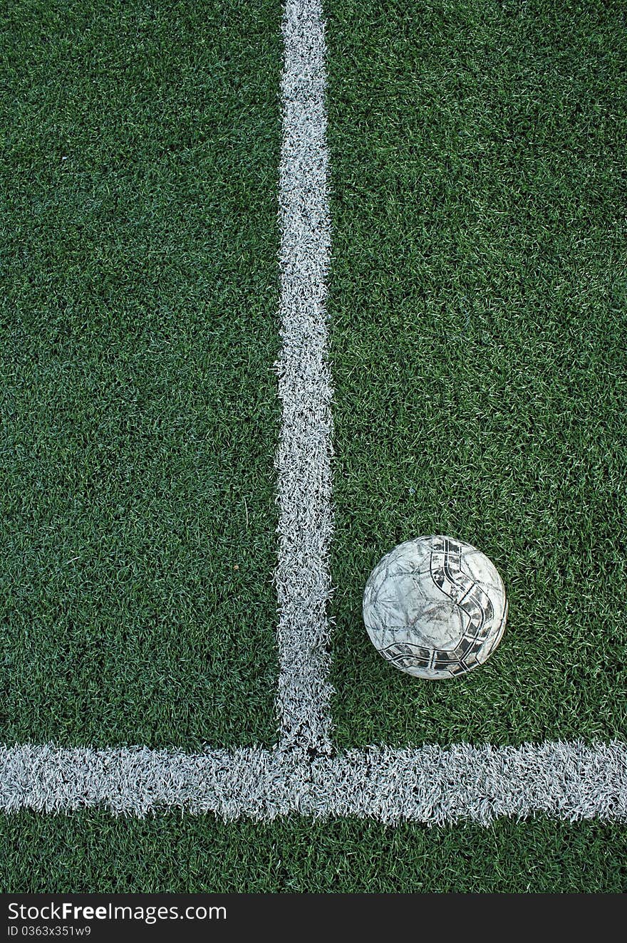 Artificial grass soccer field and old football