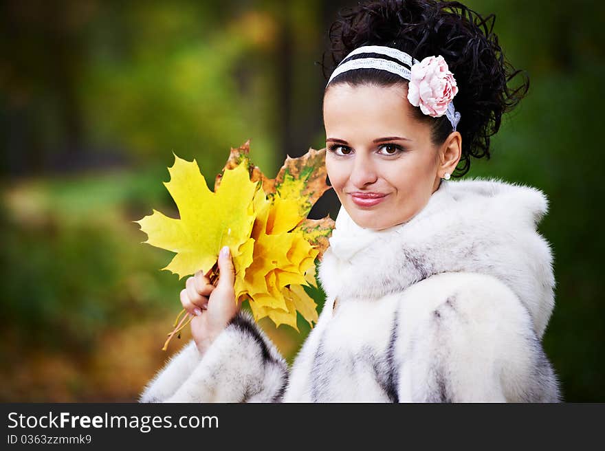 Style happy bride with yellow leaves in autumn park on wedding walk