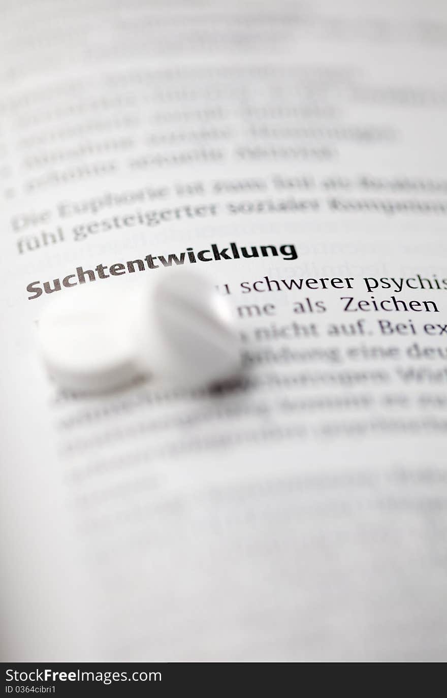 Addiction word (german) and pills selective focus