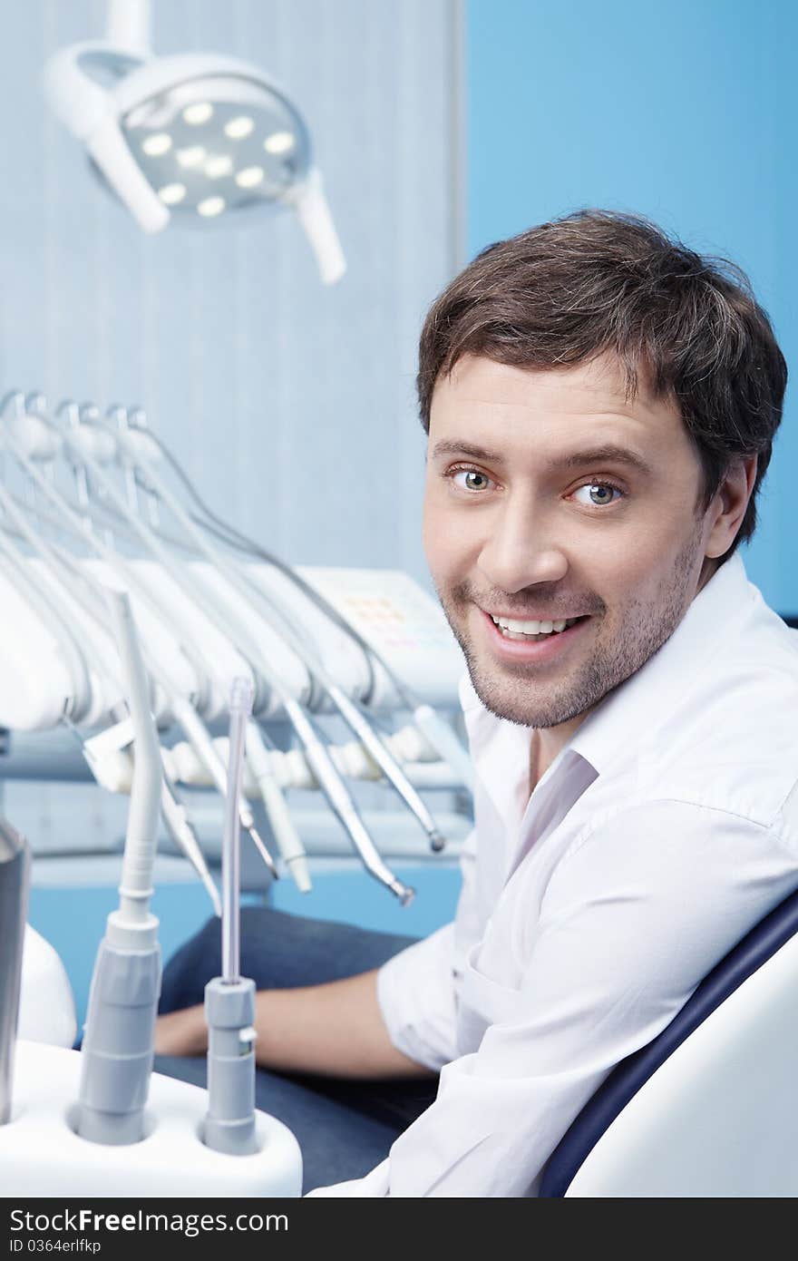 A young man in a dental clinic. A young man in a dental clinic