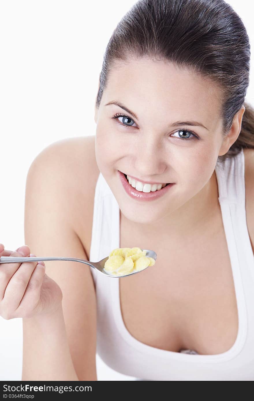 Attractive young girl with corn flakes. Attractive young girl with corn flakes