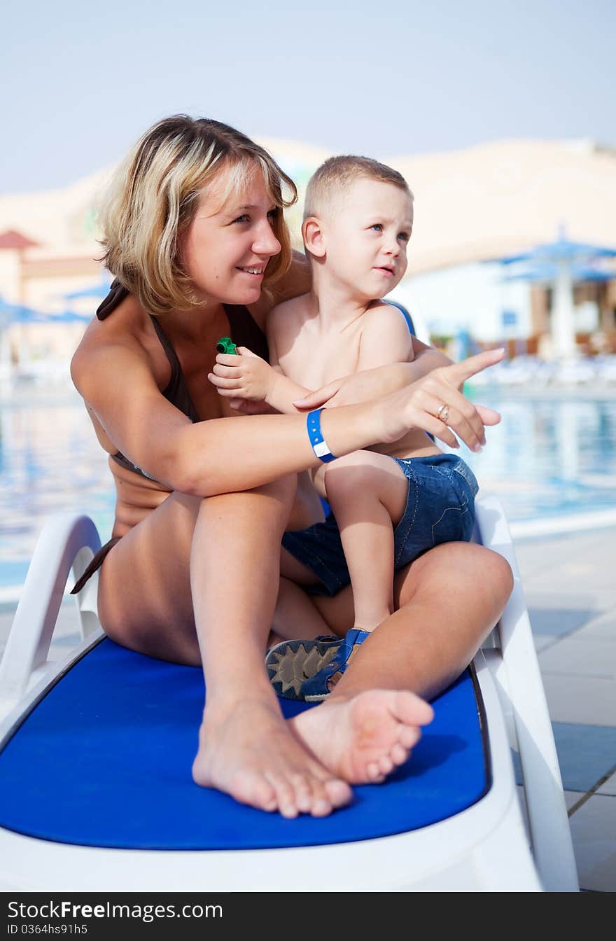 Mum With The Son Sit On A Chaise Lounge